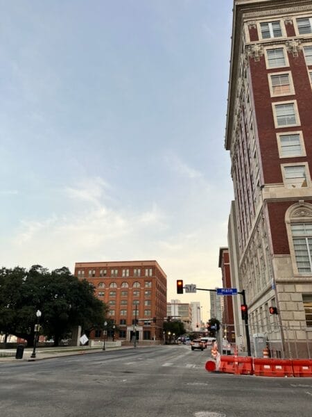 a traffic light on a city street with a building in the background