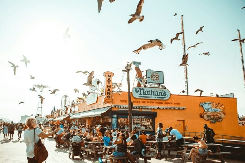 Coney Island, group of people watching flying birds outdoors