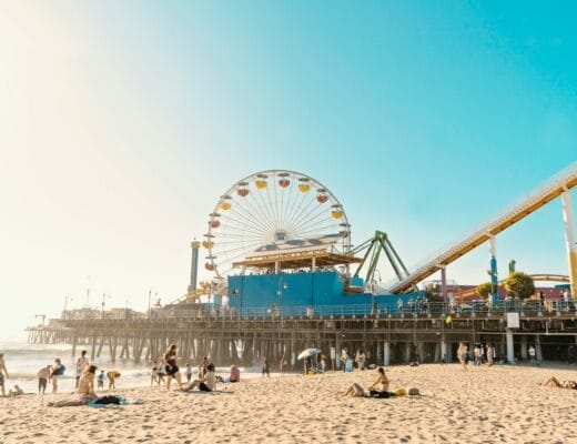 photo of yellow and white Ferris Wheel and seashore