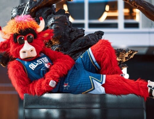Benny the Bull, la mascotte iconique des Chicago Bulls, allongé en tenue All-Star devant la statue de Michael Jordan