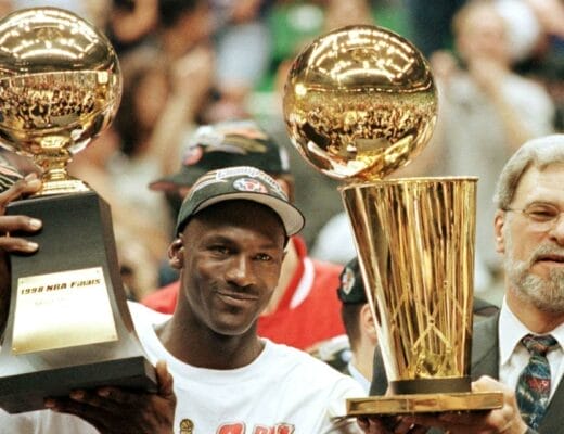 Michael Jordan et Phil Jackson célébrant le sixième titre NBA des Chicago Bulls en 1998, trophées Larry O’Brien et MVP des Finales en main