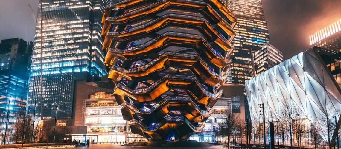 lighted building near body of water during night time