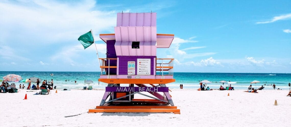 brown wooden lifeguard chair on beach during daytime