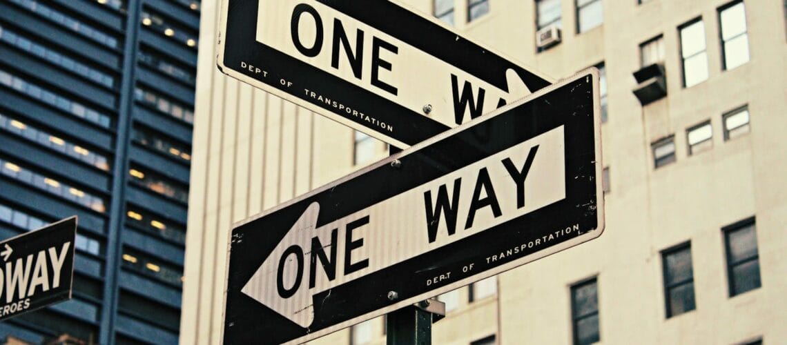 white and black One Way-printed road signages